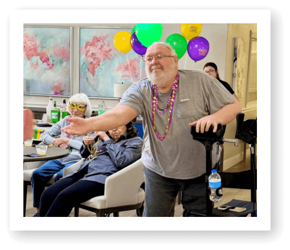 Elderly Man Dancing at Mardi Gras Celebration Event at Assisted Living Facility
