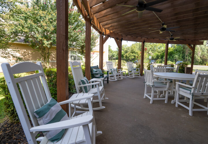 Covered Outdoor Patio with Rocking Chairs at Assisted Living Facility Covered Outdoor Patio with Rocking Chairs at Assisted Living Facility