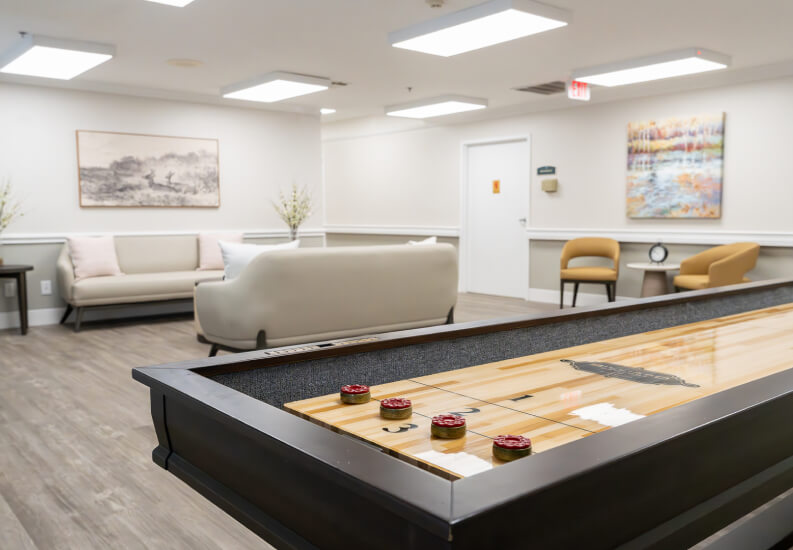 Game Room Shuffleboard Table with Lounge Seating at Assisted Living Facility Game Room Shuffleboard Table with Lounge Seating at Assisted Living Facility