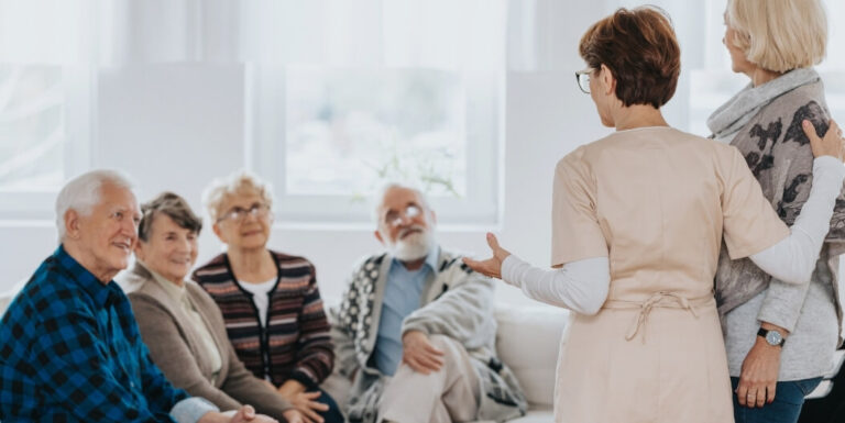 Female Nurse Leading a Seated Support Group for Elderly Residents at Assisted Living Facility